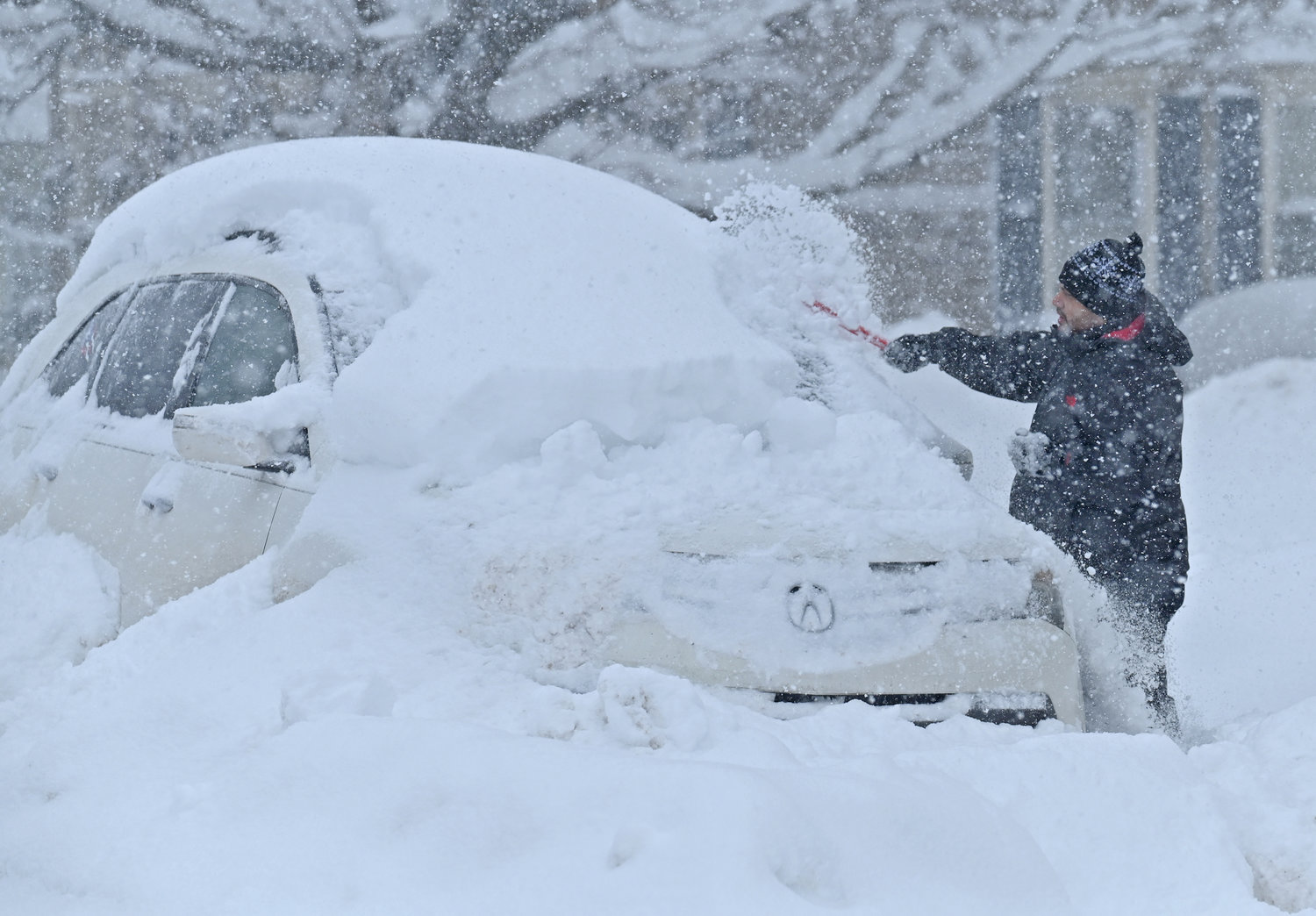 Paul Miranda 9642 Main St. cleans off his car during the big snowstorm in Remsen Monday, December 19, 2022.