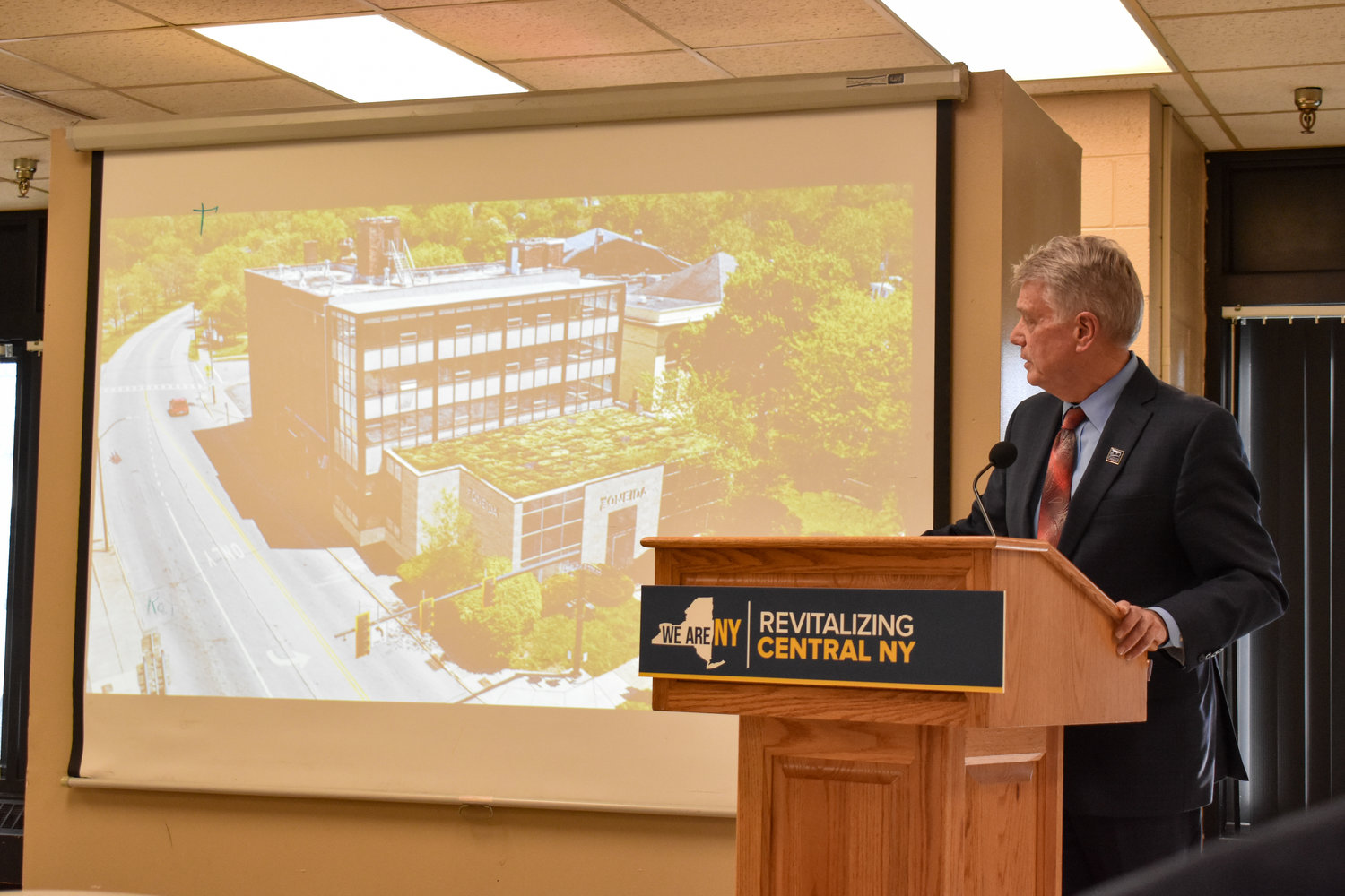 New York State Canal Corporation Director Brian Stratton announced the eight projects to be awarded Downtown Revitalization Initiative (DRI) funding in the City of Oneida. Pictured is a rendering of a rehabilitated Hotel Oneida.