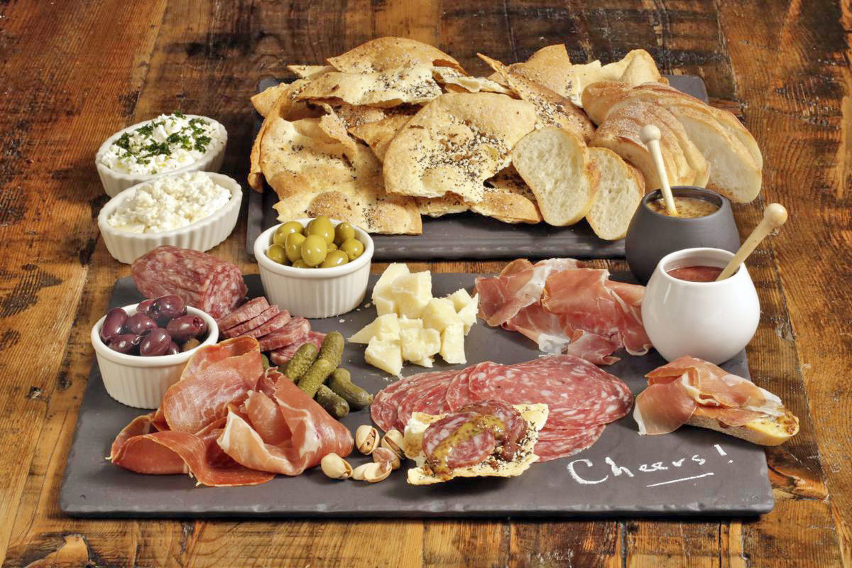 A charcuterie platter with sweet and sharp mustard. This dish is from a recipe by Elizabeth Karmel.