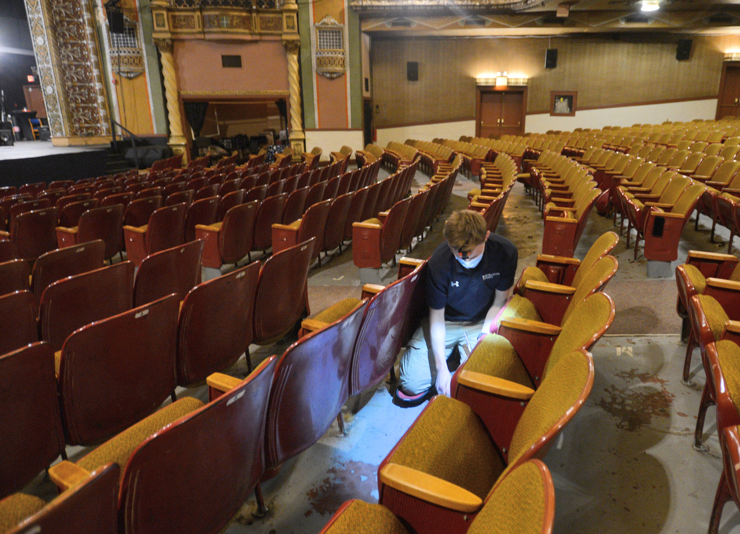 Workers from Kentucky dismantle the old seats at the Capitol Theatre in Rome. The original seats were installed in 1952.