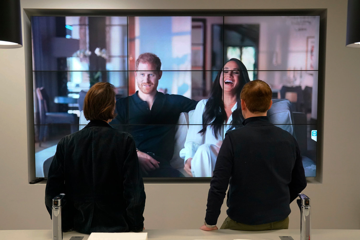Office workers in London, watch the Duke and Duchess of Sussex's controversial documentary being aired on Netflix Thursday, Dec. 8, 2022. Britain‚Äôs monarchy is bracing for more bombshells to be lobbed over the palace gates as Netflix releases the first three episodes of a new series. The show ‚ÄúHarry &amp; Meghan‚Äù promises to tell the ‚Äúfull truth‚Äù about Prince Harry and his wife Meghan‚Äôs estrangement from the royal family. The series debuted Thursday. (Jonathan Brady/PA via AP)