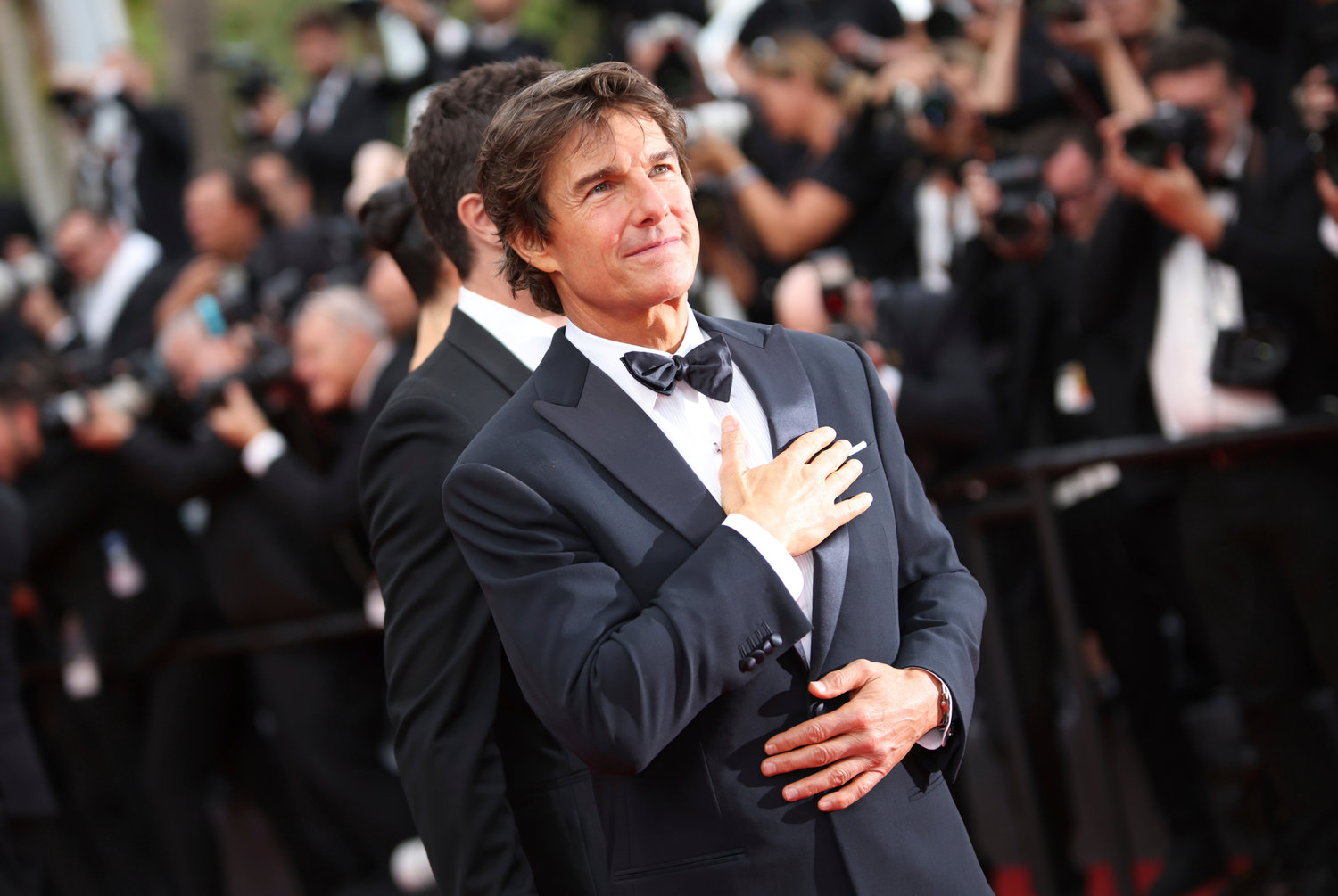 FILE - Tom Cruise gestures at the premiere of his film "Top Gun: Maverick" at the 75th international film festival, Cannes, southern France, on May 18, 2022. (Photo by Vianney Le Caer/Invision/AP, File)