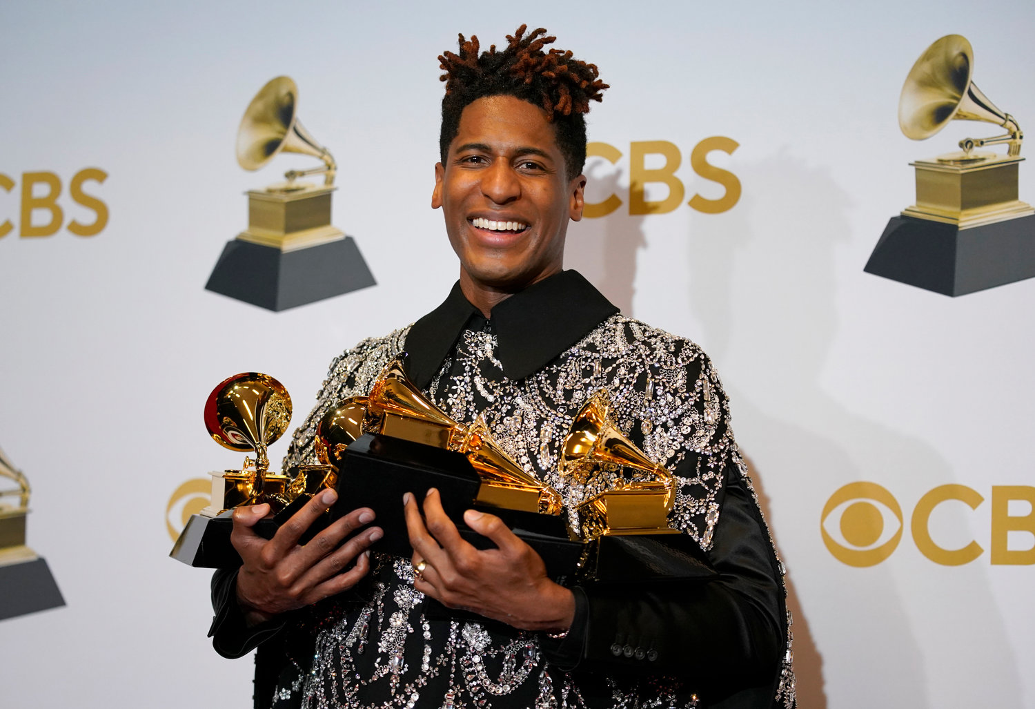 FILE - Jon Batiste, winner of the awards for best American roots performance for "Cry," best American roots song for "Cry," best music video for "Freedom," best score soundtrack for visual media for "Soul," and album of the year for "We Are," poses in the press room at the 64th Annual Grammy Awards at the MGM Grand Garden Arena on April 3, 2022, in Las Vegas. (AP Photo/John Locher, File)