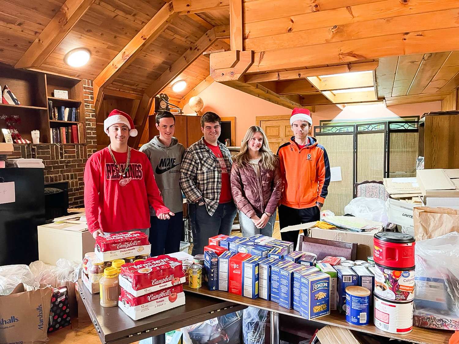 Notre Dame Junior/Senior High School seniors, from left, Santino Alsante, Trey Murnane, Paul Caruso, Carli Grabinski and Casimir Krauza delivered food Dec. 21 from their food pantry at the Utica school to the Rome Rescue Mission.