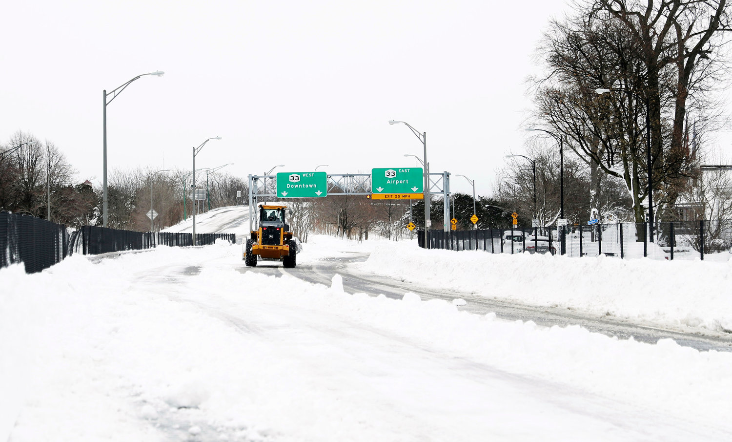 Legend Excavating owner Travis Storer works to remove snow off Route 33 in Buffalo on Tuesday, Dec. 27.
