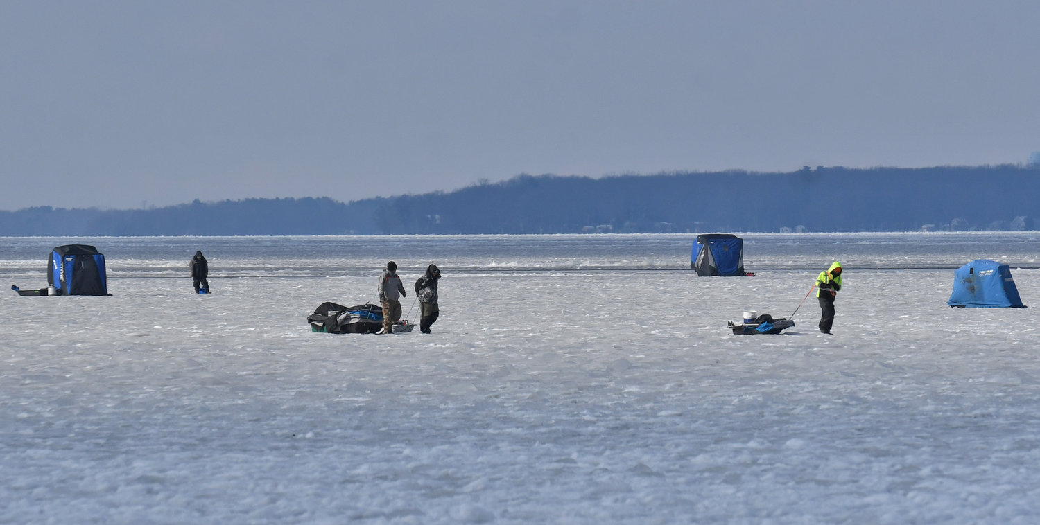 Anglers with their sleds loaded with equipment head out onto the ice on Oneida Lake on Tuesday, Dec. 27, as viewed from the Sylvan Beach shore. The popular hobby draws a variety of enthusiasts from across the region — but before heading out on the ice the state Department of Environmental Conservation urges anglers to brush up on safety.