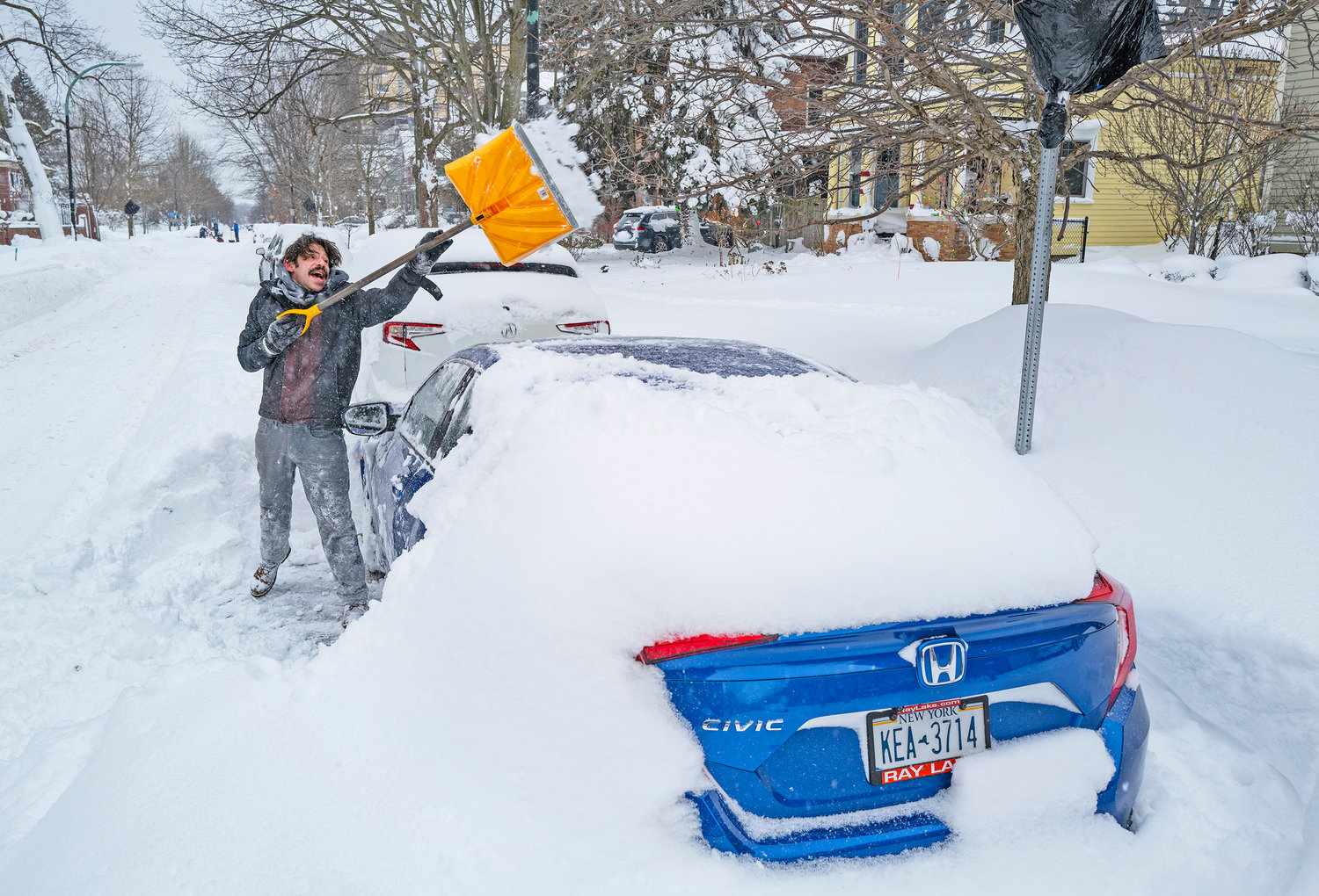 Christian Parker shovels out his car in the Elmwood Village neighborhood of Buffalo. Monday, Dec. 26, after a massive snow storm blanketed the city.