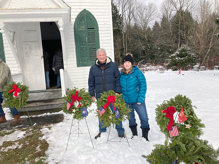 Lions Mike Keenan, left, and Tanya Moore joined the Wreaths Across America honoring of American veterans Dec. 17 at Wright Settlement Cemetery in Rome.