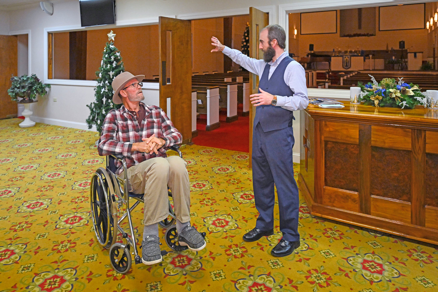 Jerry Lamb, who has a spine condition, talks to Pastor Adam Kelchner at Camden First United Methodist Church Thursday, Dec. 8, in Camden, Tenn.