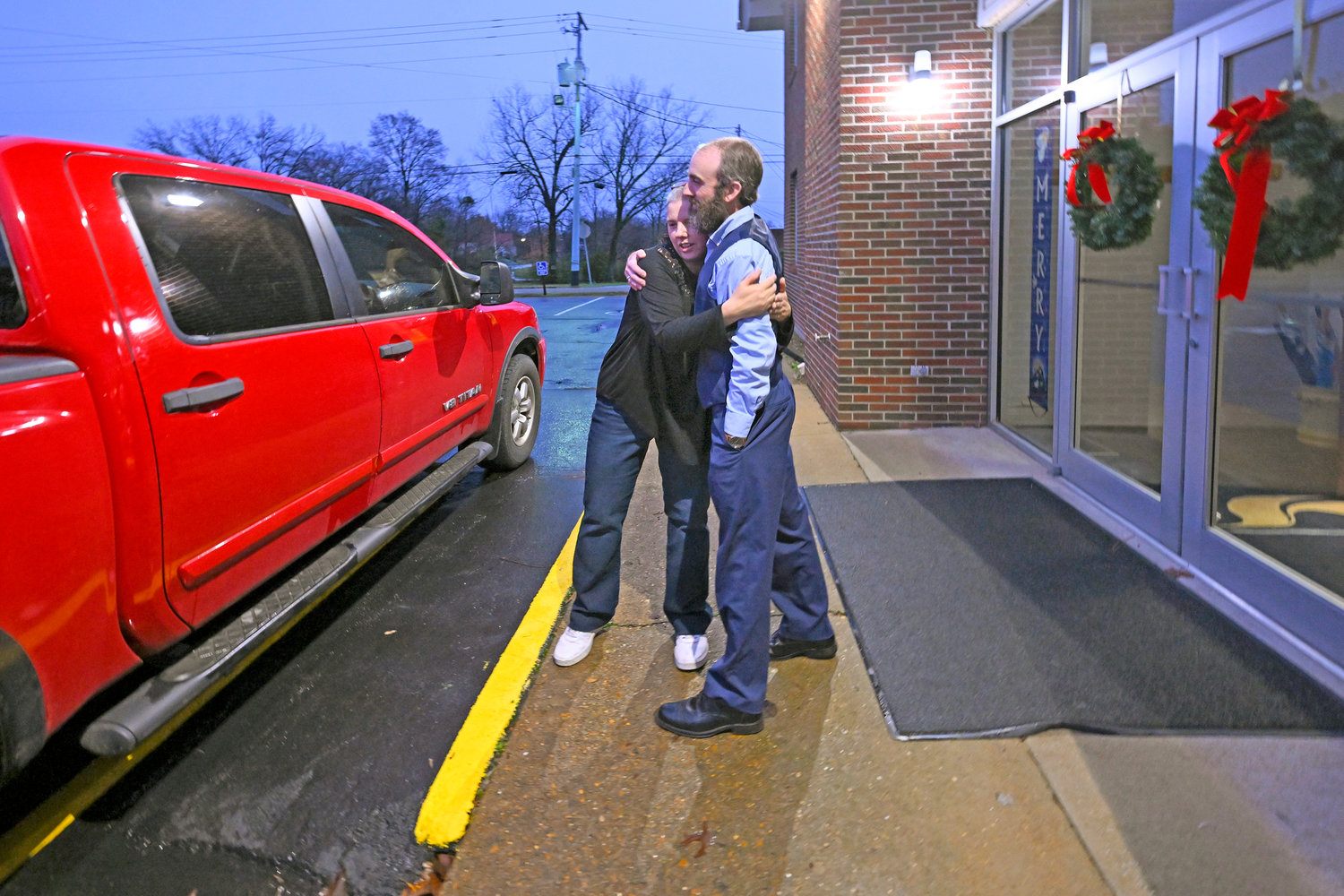 Laura Lamb, left, hugs Pastor Adam Kelchner after helping her husband, Jerry, who has a spine condition, into their truck while leaving Camden First United Methodist Church Thursday, Dec. 8, in Camden, Tenn. The church at the urging of the pastor recently had a couple pews cut in half so Jerry, and anyone else who uses a wheelchair, walker or other aid, can still sit with the rest of the congregation.