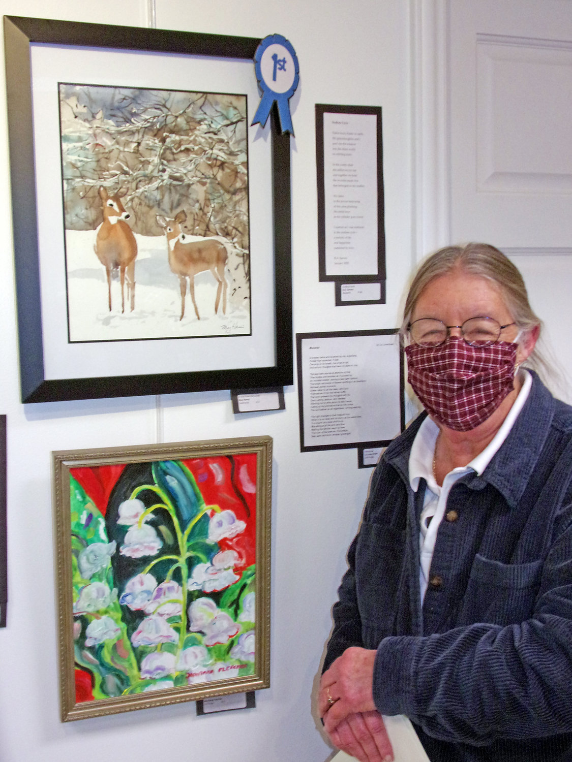 Meg Harris stands in front of her winning entry in the 2022 Poetry and Art Contest and Exhibit.