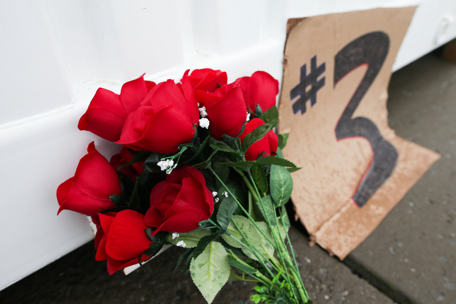 Flowers and a sign showing support for Buffalo Bills safety Damar Hamlin sits outside Highmark Stadium on Wednesday in Orchard Park.