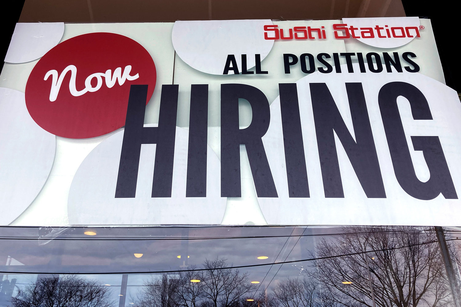 A hiring sign is displayed at a restaurant in Rolling Meadows, Ill., Tuesday, Dec. 27, 2022. On Wednesday, the Labor Department reports on job openings and labor turnover for November.