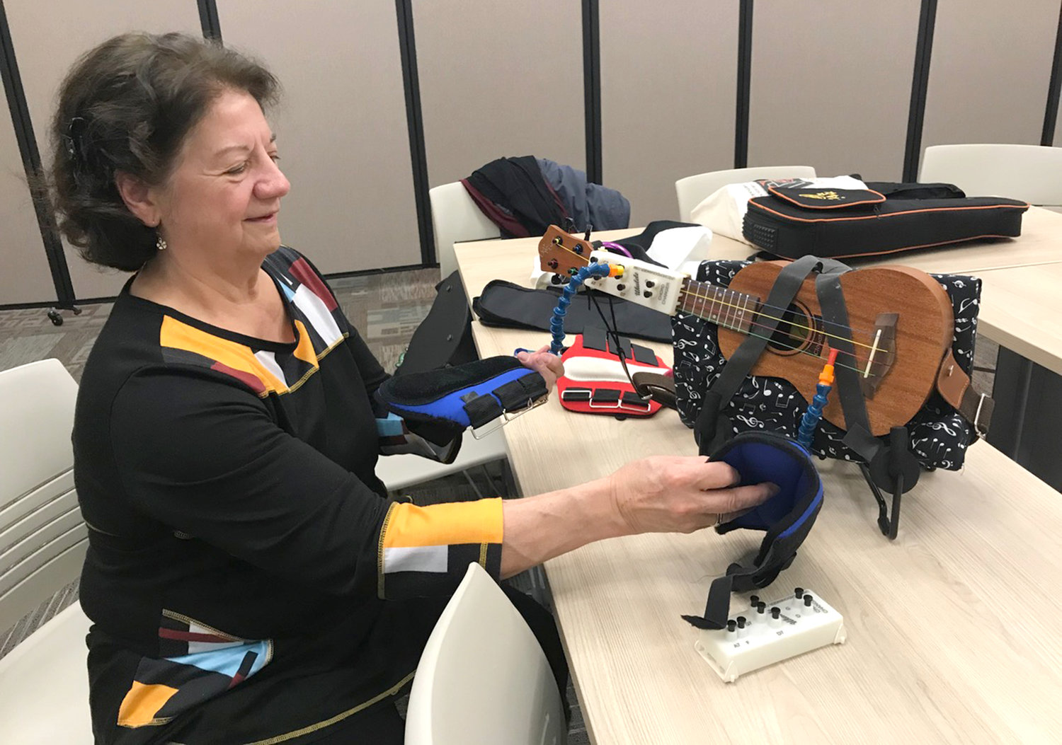 System Designer and Developer Deborah Guarneiri of the Ukulele Support System displays her invention of a ukulele that can be played by a person with no upper limbs Wednesday, Jan. 4 at the Oneida Public Library.