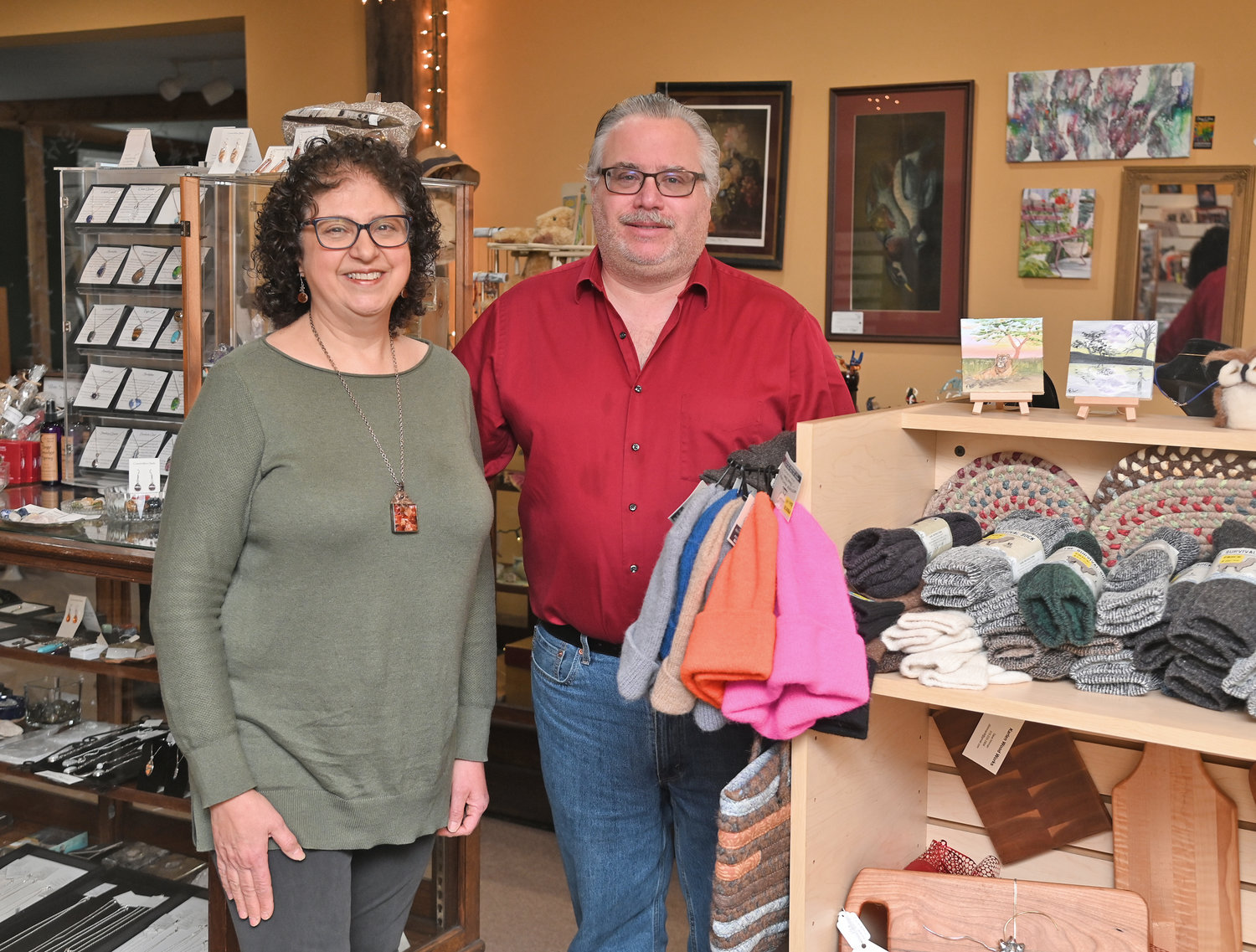 Maria and Alan Ringlund in the Photo Shoppe Fusion Art & Gift Gallery on Turin Road, where they stand among the goods made by local artists available for sale at their shop. The couple has officially announced their retirement.