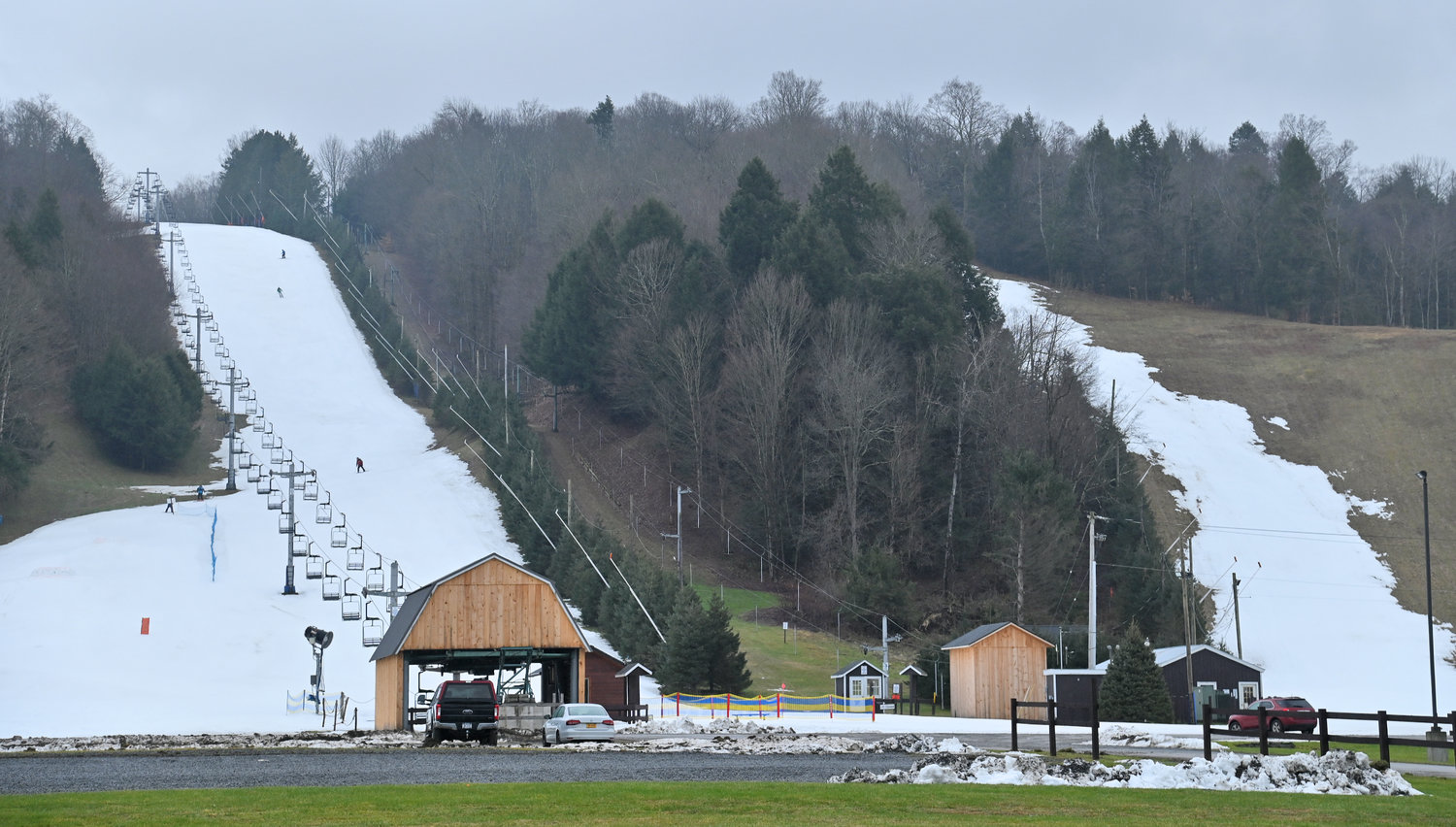 Strips of snow lay on the majority-grass hill at Woods Valley Ski Area on Friday, January 6, 2023.