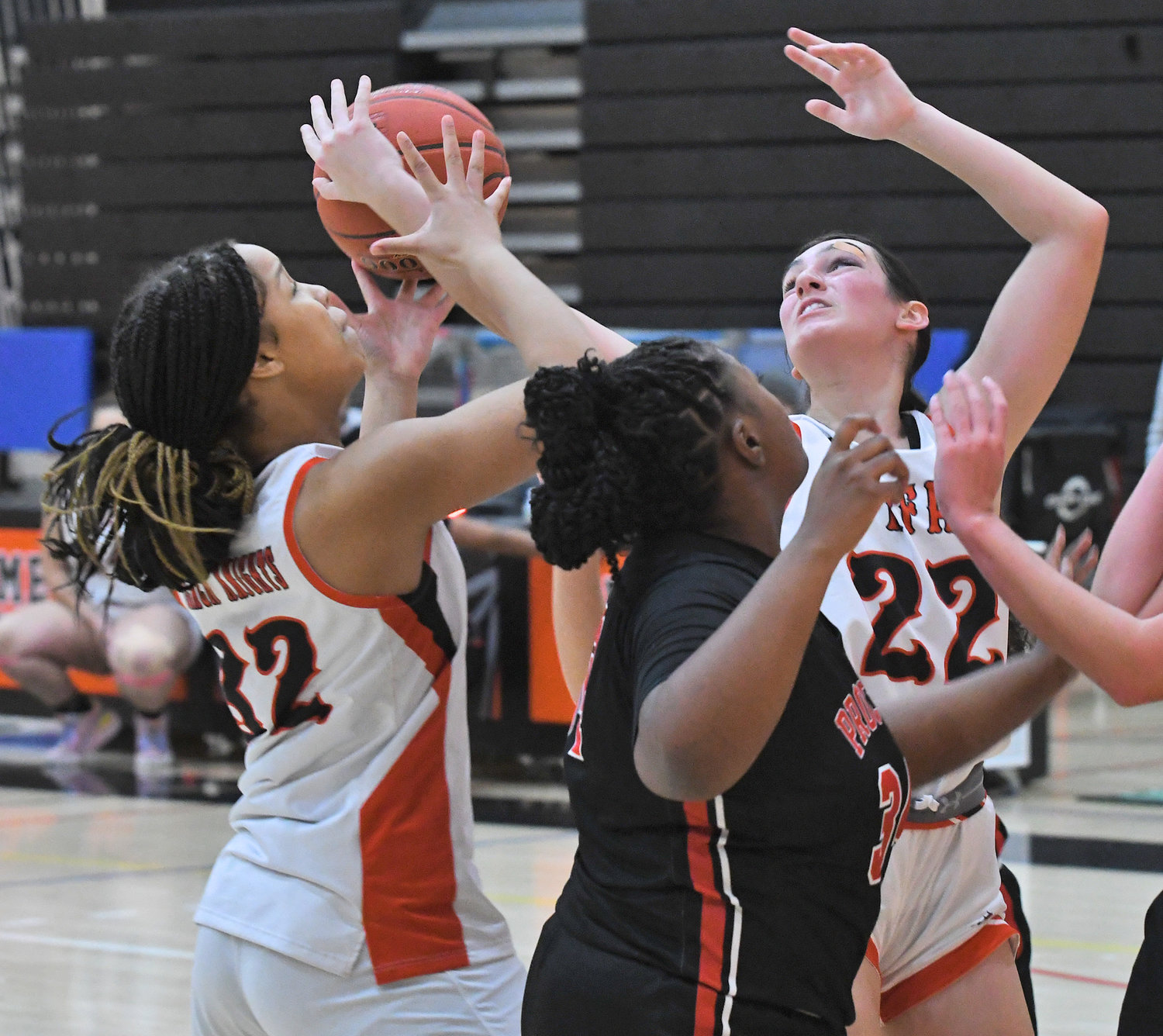 Rome Free Academy's Najae Matthews, left, and Mia Mirabelli, right, try to get control of the ball with Proctor's Anijah Buckingham in the middle Saturday at RFA. The Black Knights won 66-34 for a home victory in the Tri-Valley League.