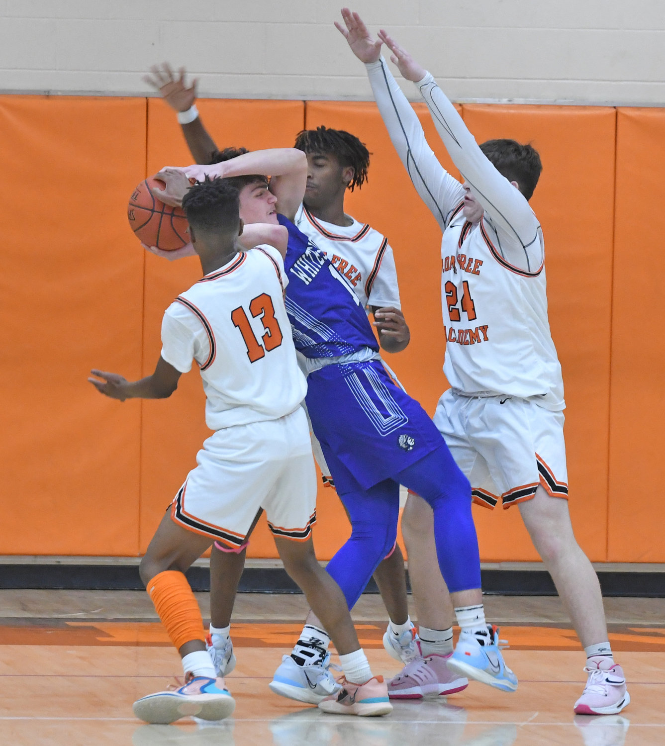 Rome Free Academy defenders swarm Whitesboro's Anthony Dorozynski Tuesday night at home. From left are Deandre Neal, Isaiah DeJean and Luke Hammon. Dorozynski led the Warriors with 12 points but the team lost 52-37.