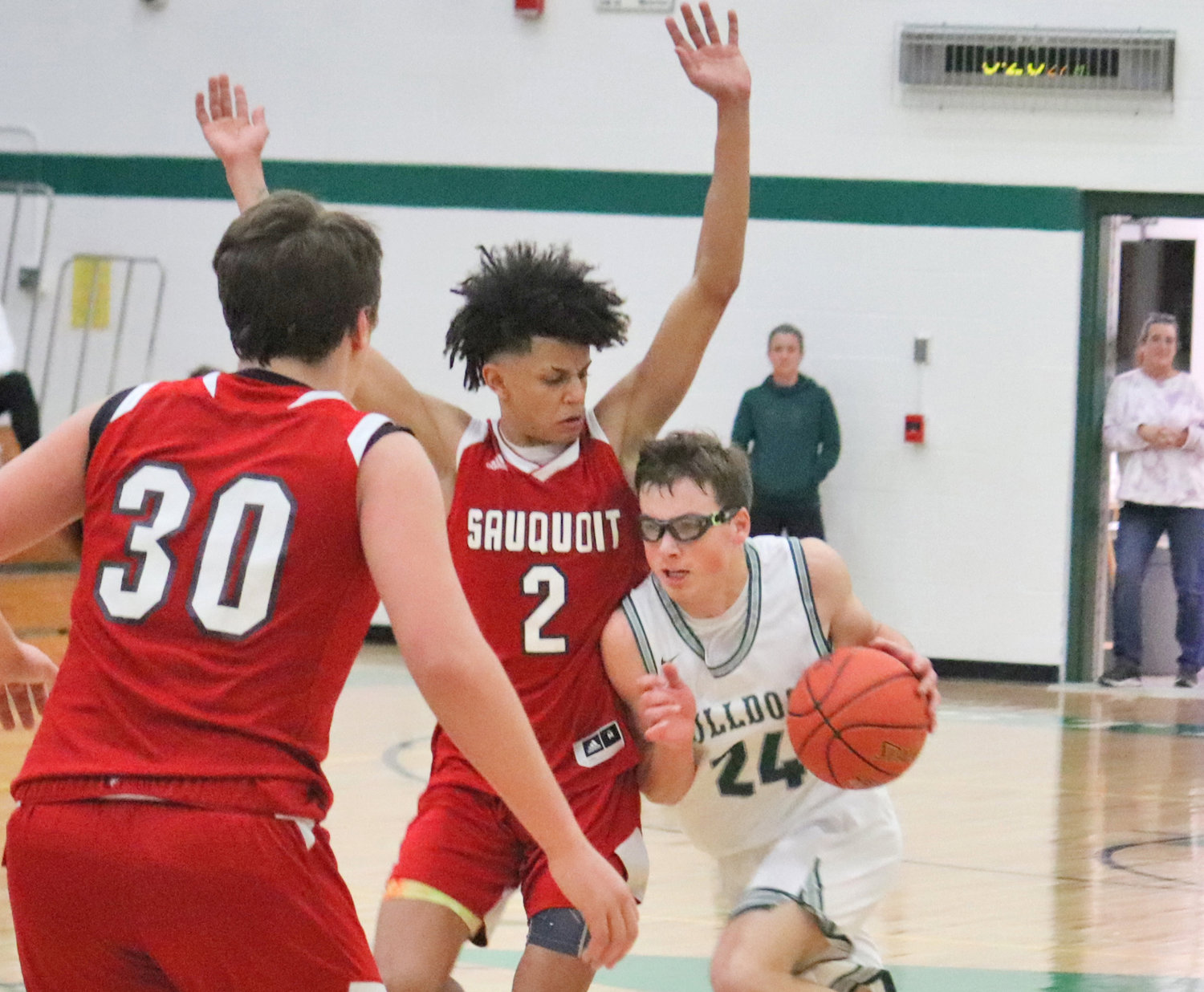Jack Williams of Westmoreland drives to the basketball against Sauquoit Valley defender Donovan Nelson Tuesday at home. Williams scored 12 points in the Bulldogs' 57-54 overtime win.