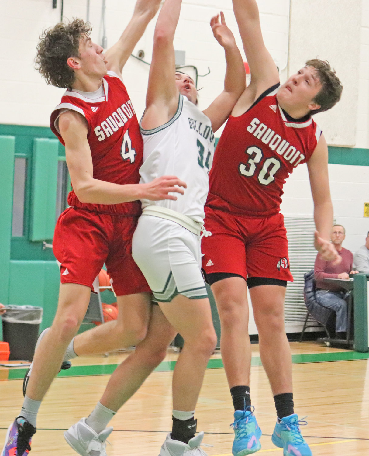 Payton Livingston of Westmoreland goes up between Sauquoit Valley's James Henck, left, and Aiden McKenney. Livingston scored 12 in the team's 57-54 overtime win at home.
