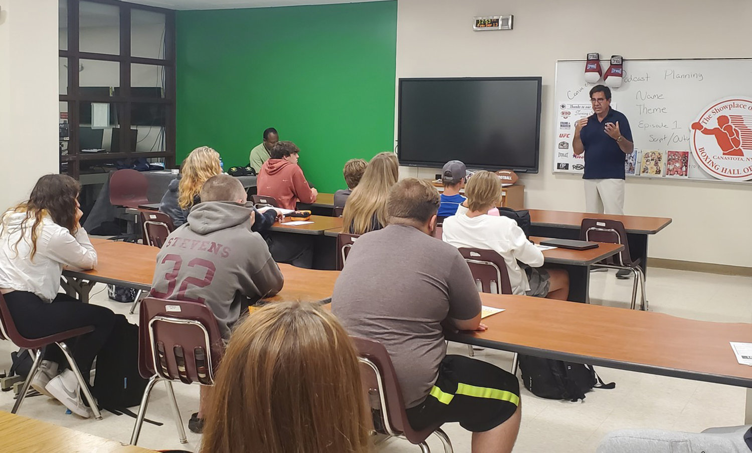 Sports Management and Entertainment Marketing program students listen to a recent classroom presentation by Ed Brophy, executive director from the International Boxing Hall of Fame in Canastota.
