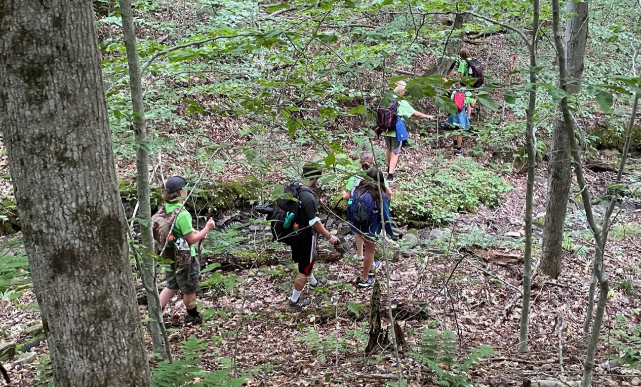 Campers in the state Department of Environmental Conservations Summer Camp program take a hike in the wilderness in this program file photo. Families are encouraged to sign up early for the 2023 DEC Summer Camp Program, officials said, as limited spaces are available for the popular program at the DEC’s four residential camps.