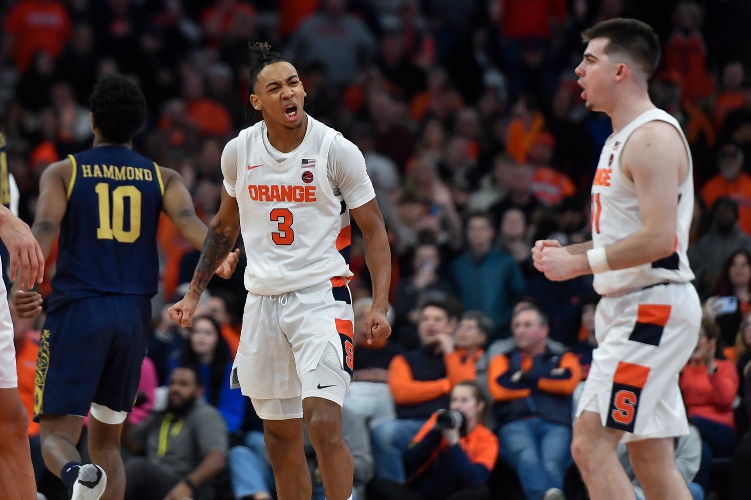 Syracuse guard Judah Mintz (3) celebrates with guard Joseph Girard III after the team's win over Notre Dame on Saturday night in Syracuse. The Orange won 78-73.