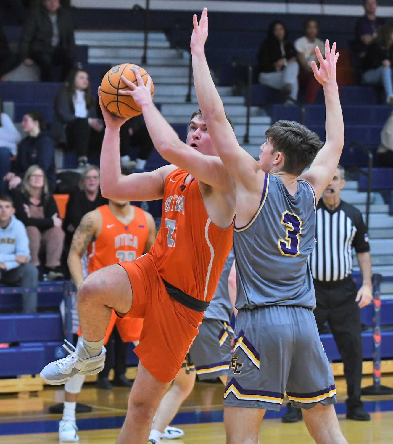 Utica University's Thomas Morreale goes up for a shot with Elmira's JJ Babcock defending during Friday night's Empire 8 game in Utica.