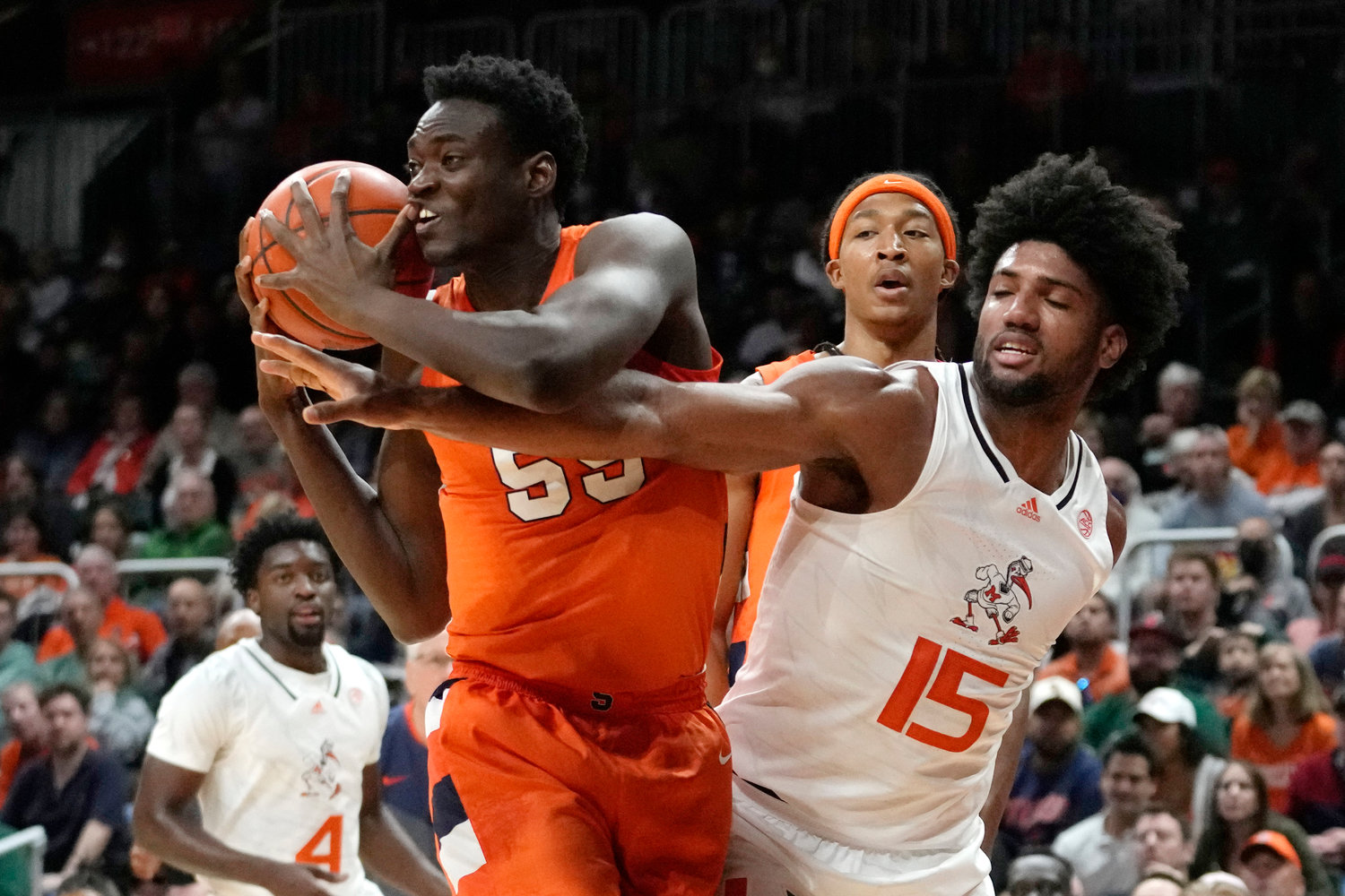Syracuse center Mounir Hima gets the ball away from Miami forward Norchad Omier (15) during the first half of Monday night's game in Coral Gables, Fla.