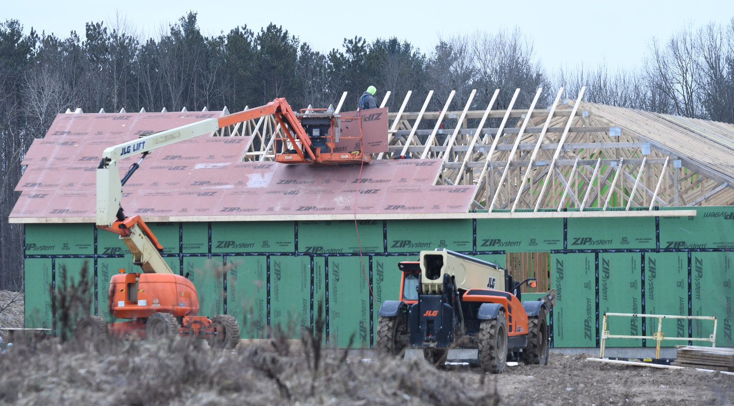 Despite a wintry mix of rain, freezing rain and snow, roof work at the housing complex under construction on Merrick Road in Rome continues on Tuesday, Jan. 17. The first phase of the 65-home project, which includes the construction of 50 units, is already well under way.