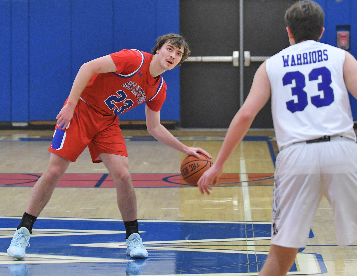New Hartford’s Zach Philipkoski watches the clock for the last shot in the first quarter with Whitesboro’s Dan Russo guarding him Monday evening at Whitesboro High School. Philipkoski scored 17 and the Spartans got a 50-27 win on the road in the Tri-Valley League.