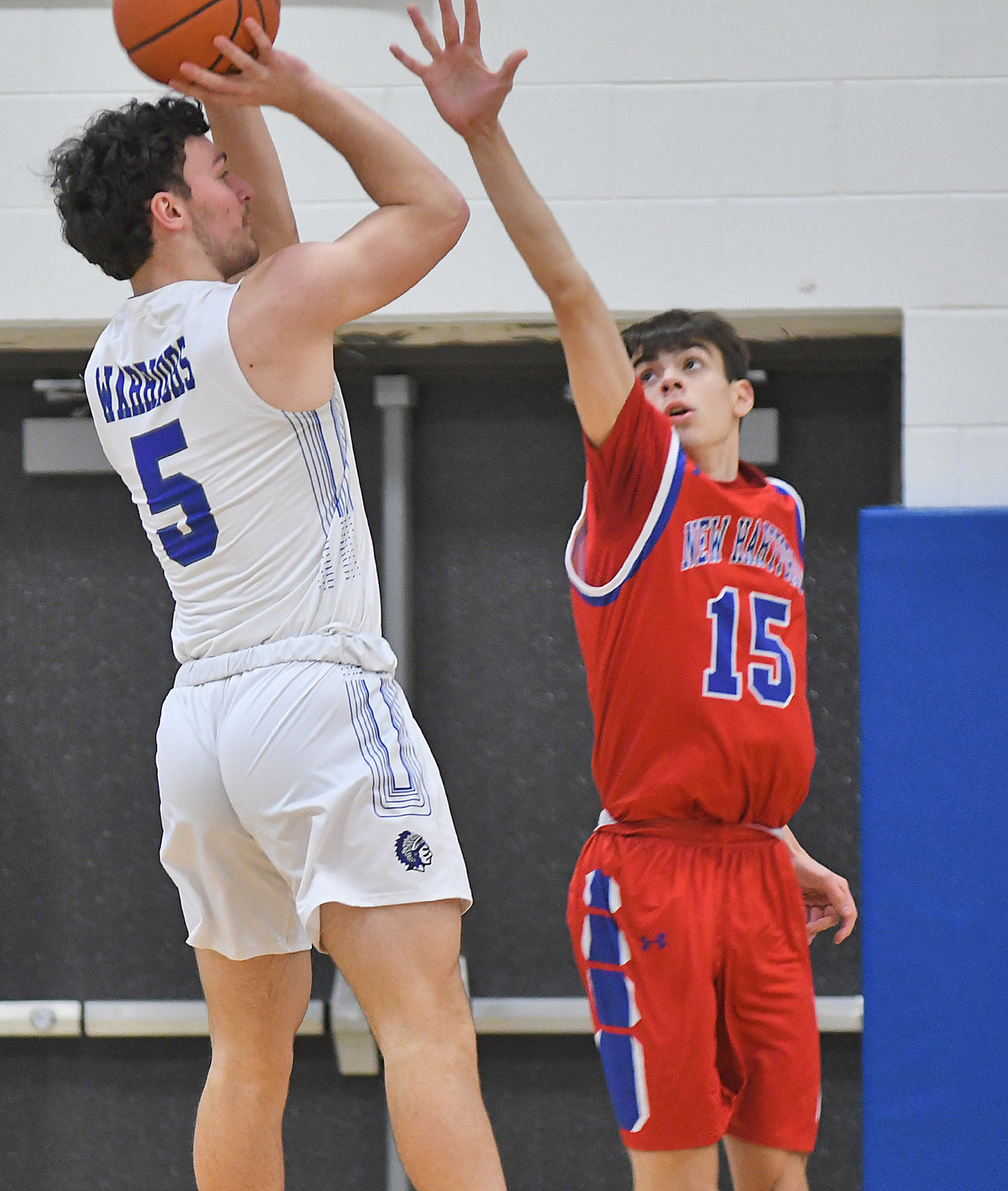 Kyle Meier of Whitesboro takes a shot with New Hartford defender Jameson Stockwell getting a hand out Monday night at Whitesboro High School. Meier led his team with 11 points and Stockwell led his with 19. New Hartford won 50-27.