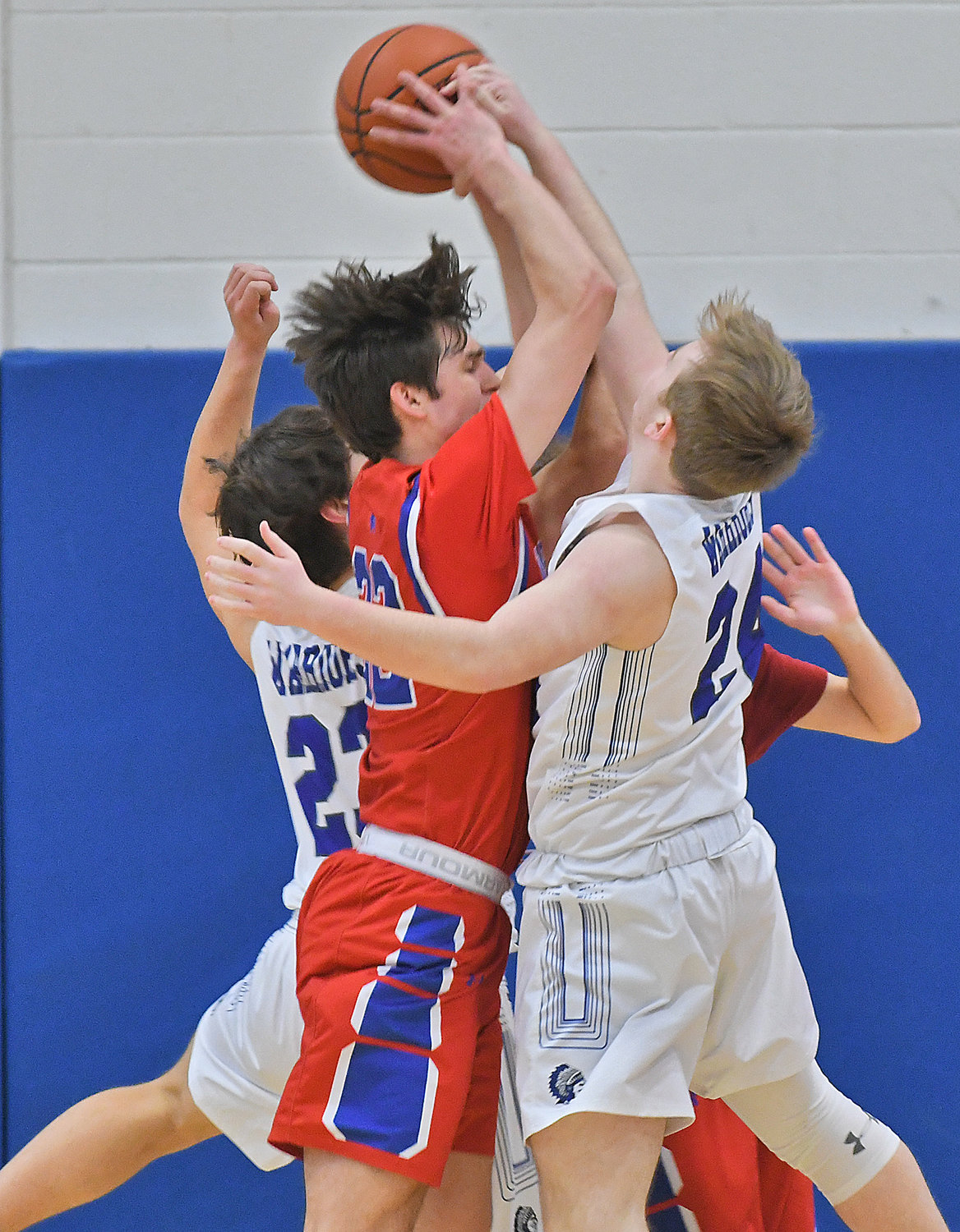 New Hartford's Colton Suriano gets tied up by Whitesboro's Ty Montrose, left, and Jason Roberts in the first half Monday at Whitesboro High School.