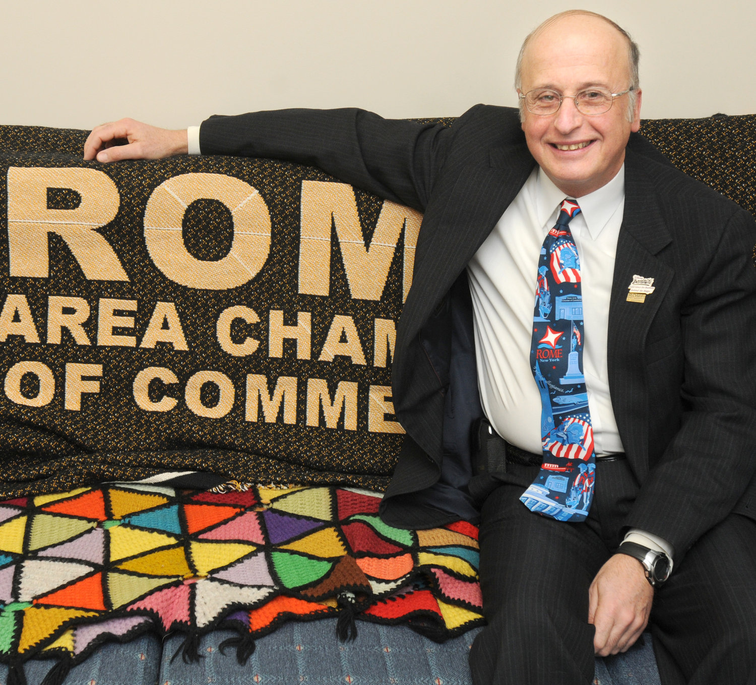 Bill Guglielmo with a Rome Area Chamber of Commerce blanket in his office downtown.