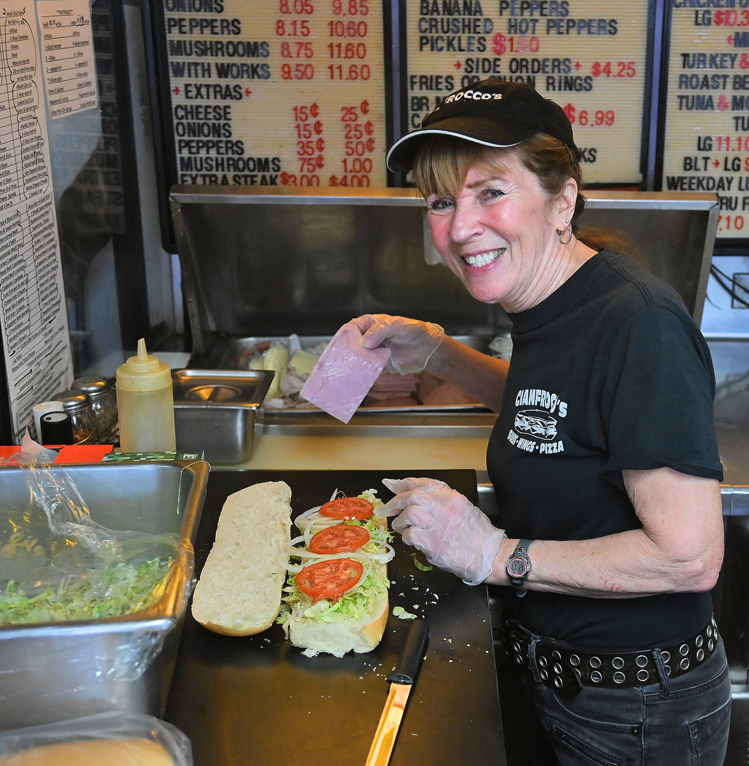 Ann Cianfrocco, owner of Cianfrocco’s Subs, Wings &amp; Pizza on East Dominick Street in Rome, makes a Wednesday special ham sub sandwich on Wednesday afternoon.