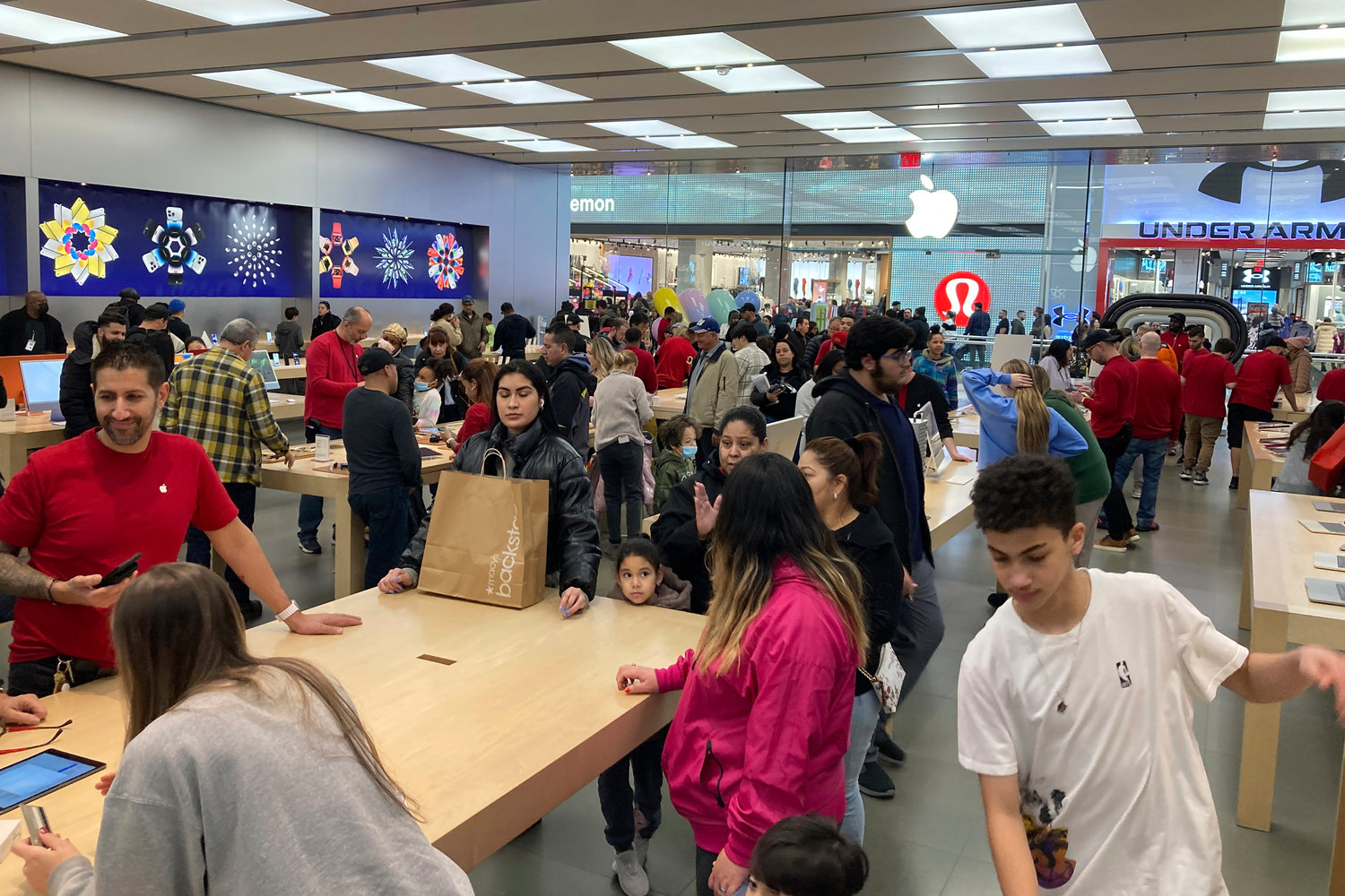 People shop at an Apple store in the Westfield Garden State Plaza mall in Paramus, New Jersey, on Saturday, December 17, 2022. On Wednesday, the Commerce Department releases U.S. retail sales data for December.