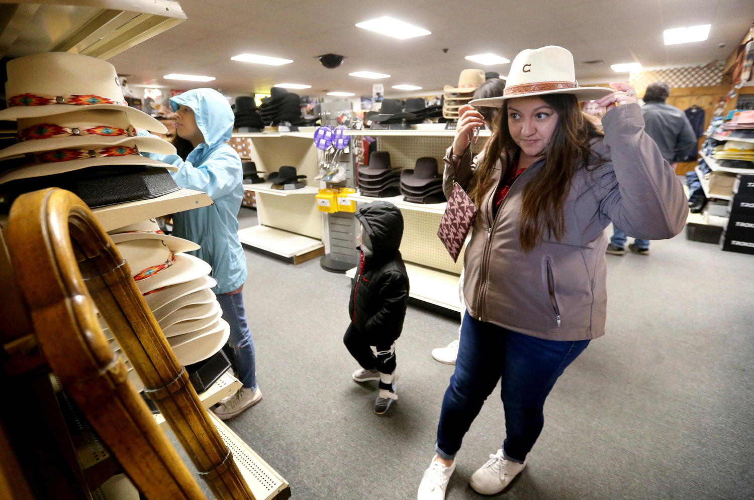 Irene Schaefer, of Johnson Creek, Wis., shops for hats at Longhorn Saddlery in Dubuque, Iowa, on Friday, Dec. 30, 2022. On Wednesday, the Commerce Department releases U.S. retail sales data for December.