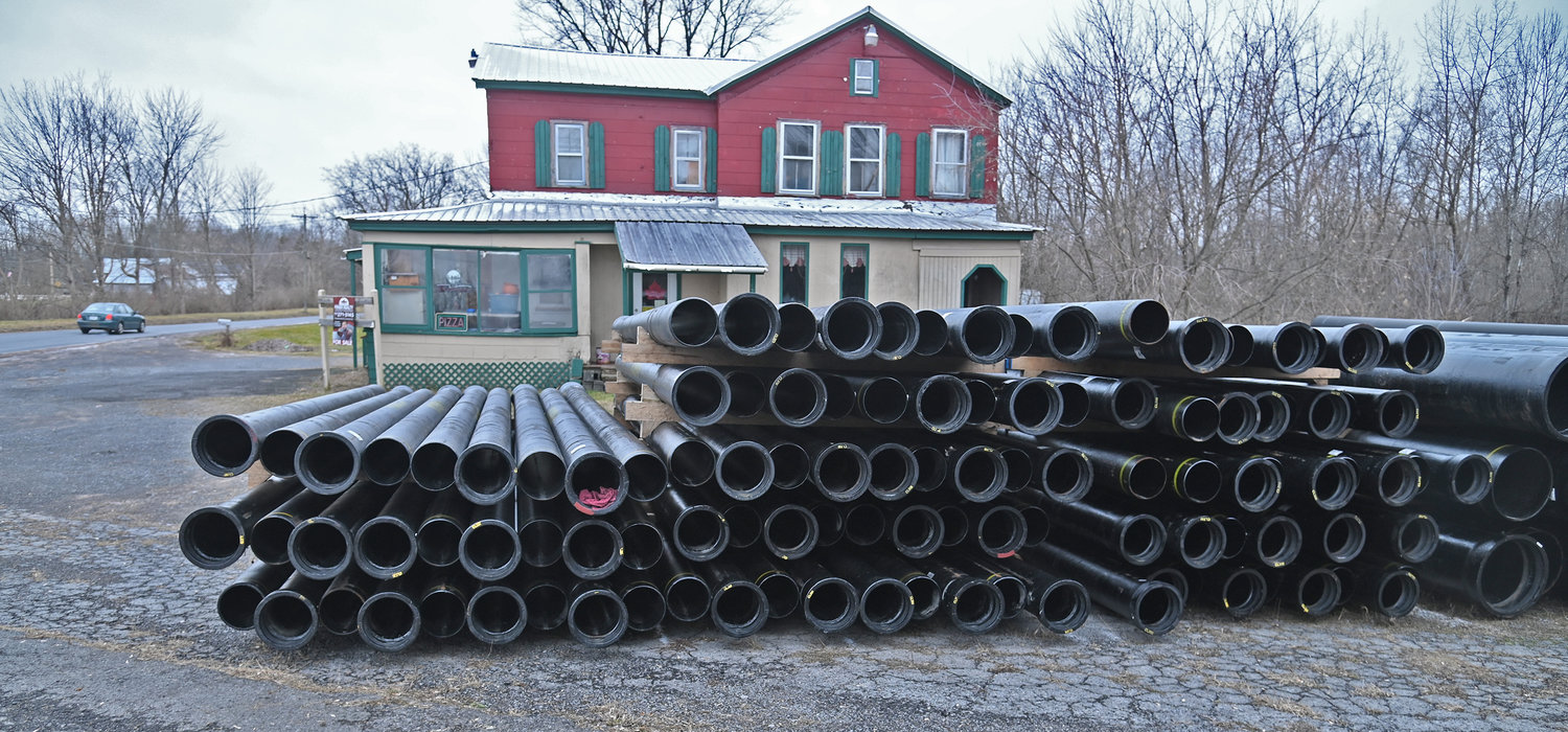 Piping stretches across the parking lot at Satch's Tavern in New London earlier this month. Verona town officials say work is progressing on project that will provide municipal water to about 500 town residents as well as install fire hydrants in some areas in the town, including New London.
