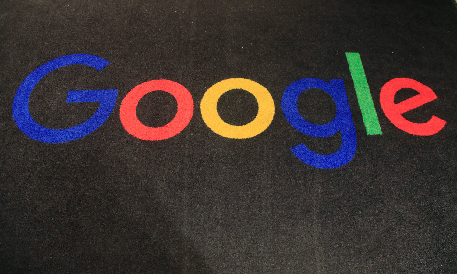 The logo of Google is displayed on a carpet at the entrance hall of Google France in Paris, on Nov. 18, 2019. Google said Friday, jan. 20, 2023, it’s laying off 12,000 workers, becoming the latest tech company to trim staff after rapid expansions during the COVID-19 pandemic have worn off.