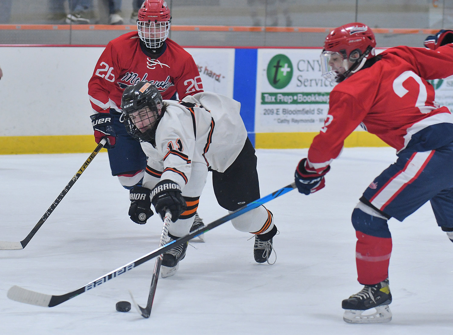 Rome Free Academy forward John Sharrino controls the puck while weaving through the defense of Niskayuna’s Dominic Calareso, left, and Luca Coppola  in the first period Friday afternoon at home in Kennedy Arena. Sharrino had three goals and two assists in the Black Knights’ 10-0 win.