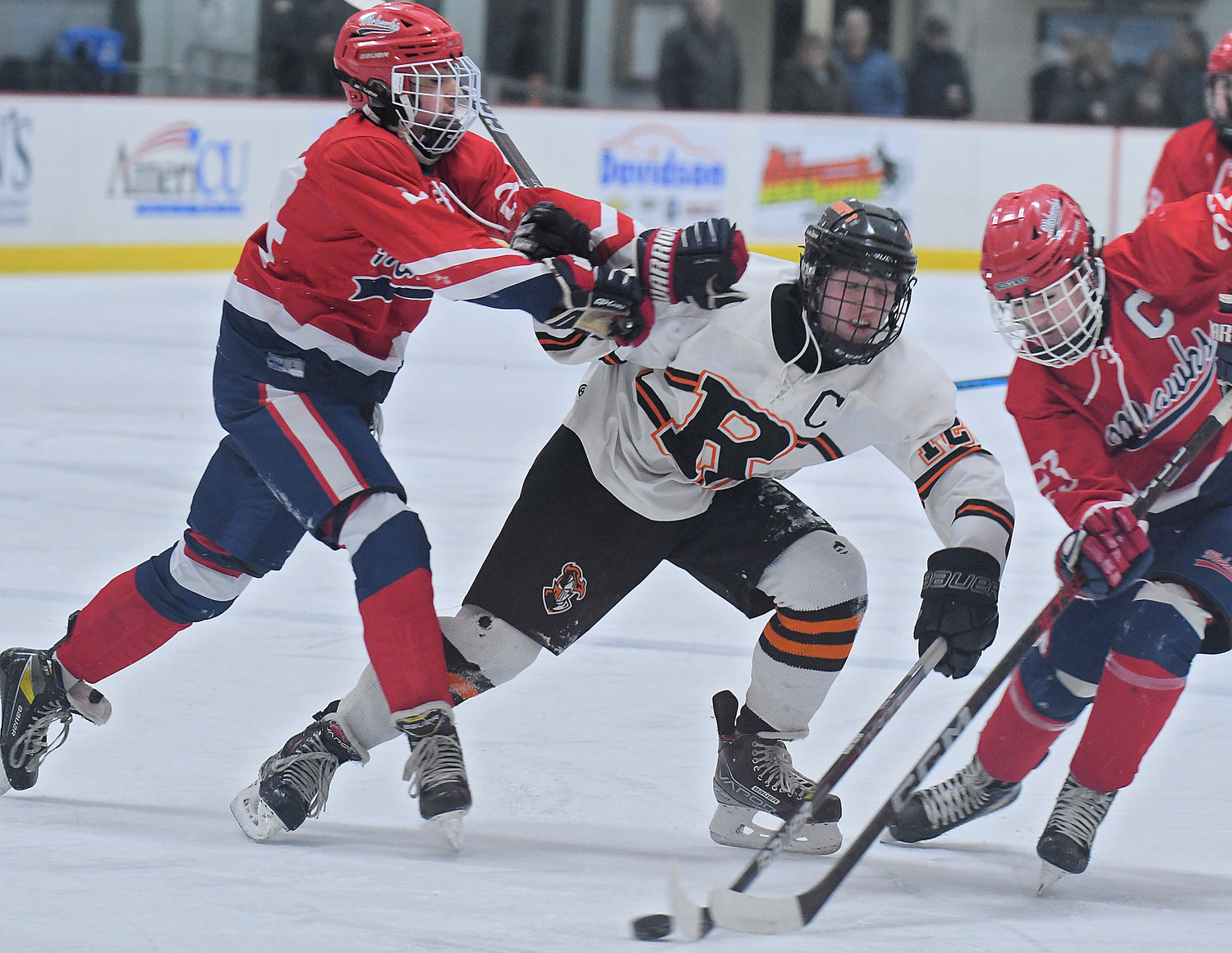 Jake Premo of Rome Free Academy splits the defense of Niskayuna's Luke Allen, left, and Peter Hans during the first period at Kennedy Arena Friday afternoon. RFA won 10-0.