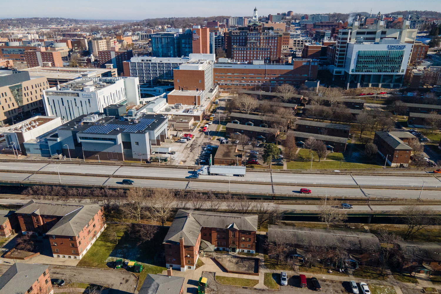 Interstate 81 passes through downtown Syracuse, New York, on Monday, Jan. 16, 2023. On the west side of the roadway are the Pioneer Homes public housing projects. Hospitals, hotels and other buildings are visible on the east side. (AP Photo/Ted Shaffrey)