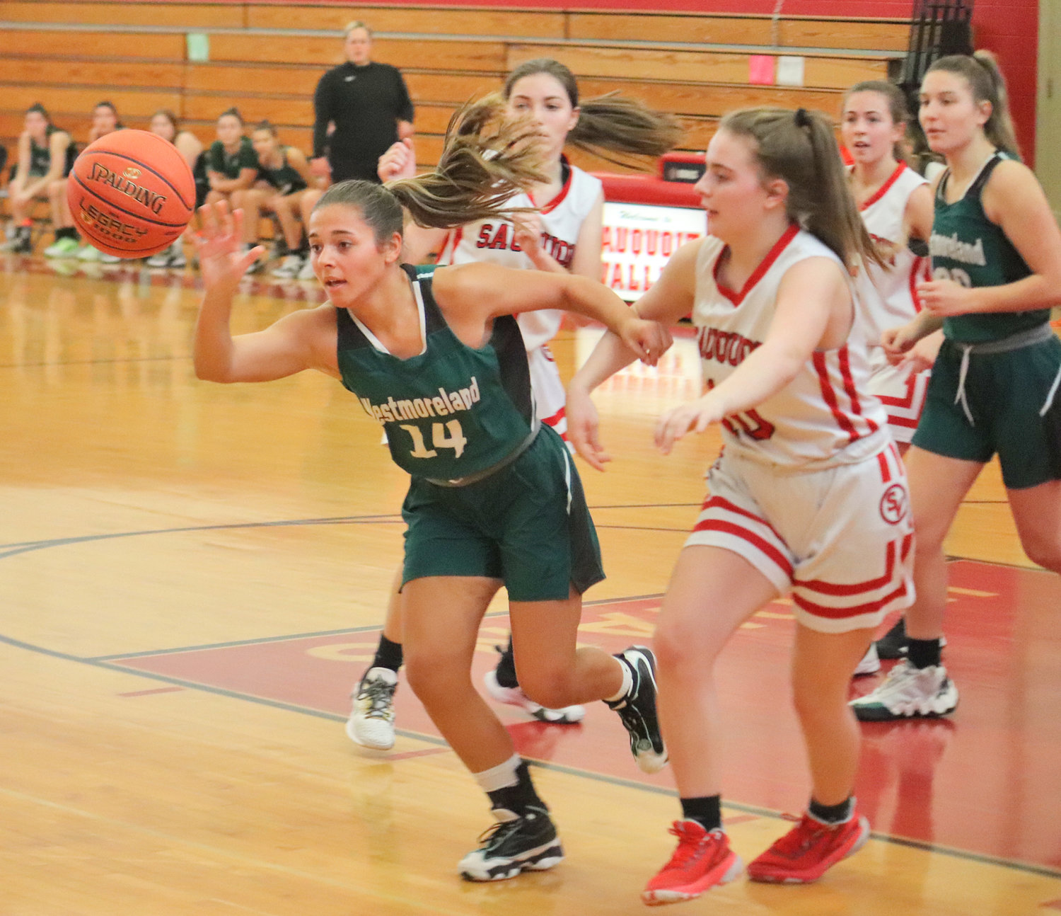Westmoreland's Olivia Moore reaches out for the ball with Sauquoit's Allison Crandall at right in a Center State Conference game Saturday in Sauquoit. Westmoreland won 45-34.