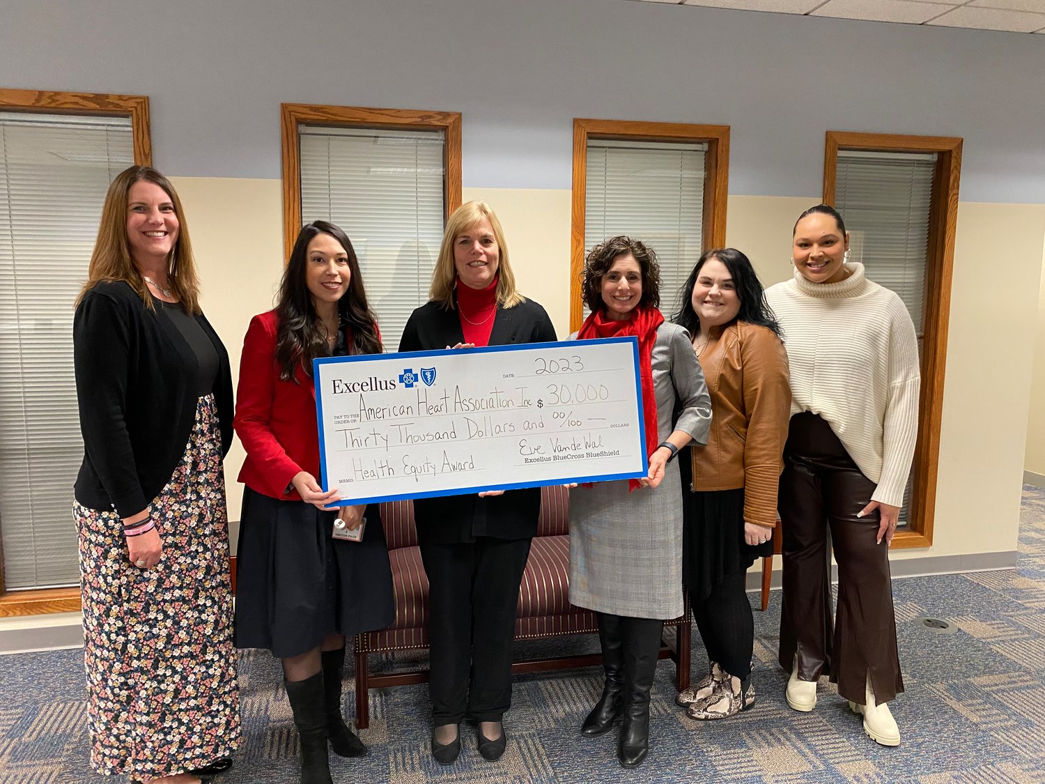 Shayna Keller, Excellus BCBS community investments and partnerships manager; Mackenzie Shorter, American Heart Association community impact director; Eve Van de Wal, Excellus BCBS regional president; Christine Kisiel, American Heart Association executive director; Marianne Hagadorn, American Heart Association development director; and Tionna DeFreitas, American Heart Association development coordinator gather for a check presentation.