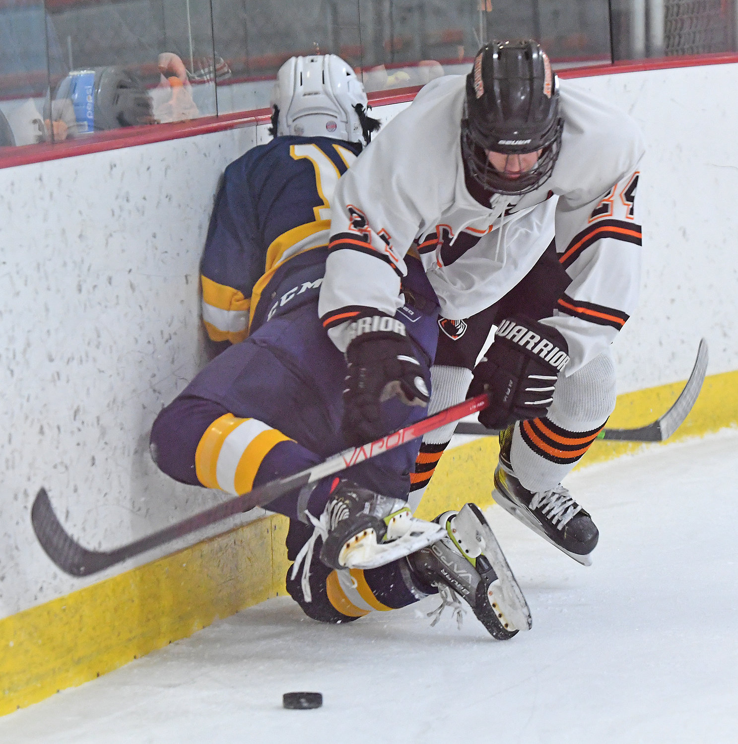 Rome Free Academy forward Jack Pylman pins West Genesee's Jesse Desena on the boards while trying to control the puck Tuesday night at Kennedy Arena. Both scored a goal but West Genny went on to a convincing 10-1 win.