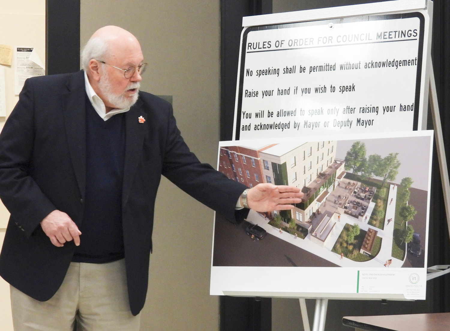 Managing Member Edward Riley shows an aerial rendering of the planned Hotel Oneida renovations, including the removal of the blue panel addition that many residents have described as an eyesore.
