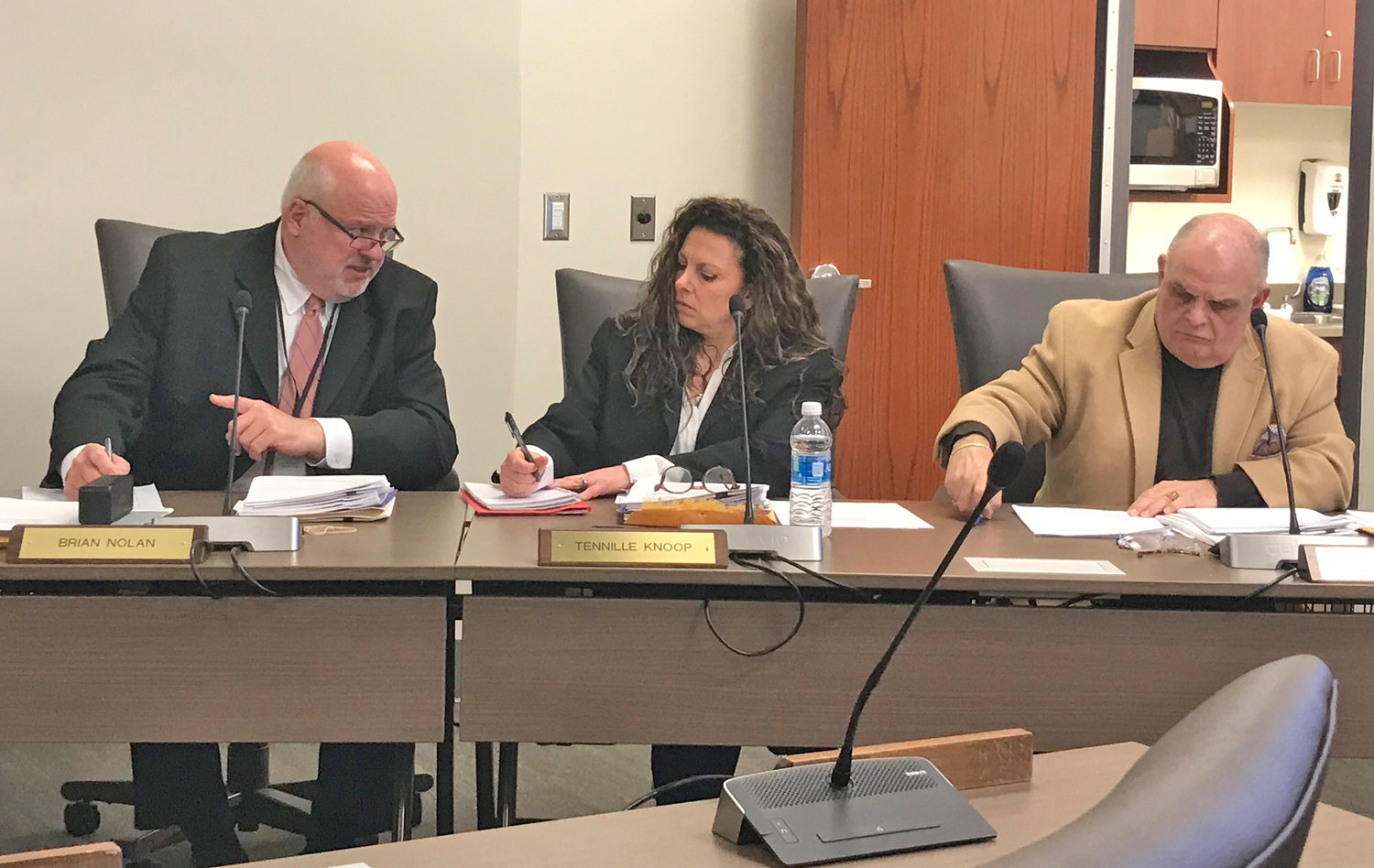 Utica City School District Acting Superintendent Brian Nolan, left, and Board of Education members Tennille Knoop, center, and Robert Cardillo listen to a report during the regular monthly board meeting Tuesday, Jan. 24 at the district's administration building in Utica.