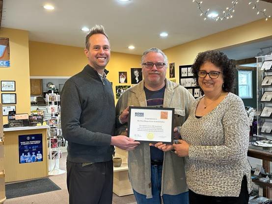 Alan and Maria Ringlund, owners of The Photo Shoppe and Fusion Art Gallery at 8584 Turin Road, are presented with a special certificate to commemorate their 30th anniversary in business from the Rome Area Chamber of Commerce. Presenting the certificate is Interim Chamber President Wesley Cupp. The Ringlunds plan to retire from their business on March 31.