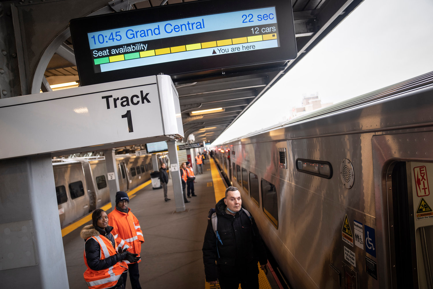 A passenger rushes to board a Long Island Rail Road train before it departs for an inaugural trip from Jamaica station towards Grand Central Terminal, Wednesday, Jan. 25, 2023, in the Queens borough of New York. After years of delays and massive cost overruns, one of the world's most expensive railway projects has begun shuttling its first passengers between Long Island to the latest addition to New York City's iconic Grand Central Terminal, dubbed Grand Central Madison because of its location along Madison Avenue. (AP Photo/John Minchillo)