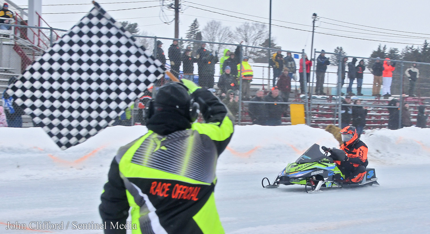 Getting the win- Jamie Bourgeois from Boonville blasts by the flag stand and wins the  2023 Pro Champ Adirondack Cup  Sunday, January 29 a the Boonville Fairgrounds.
